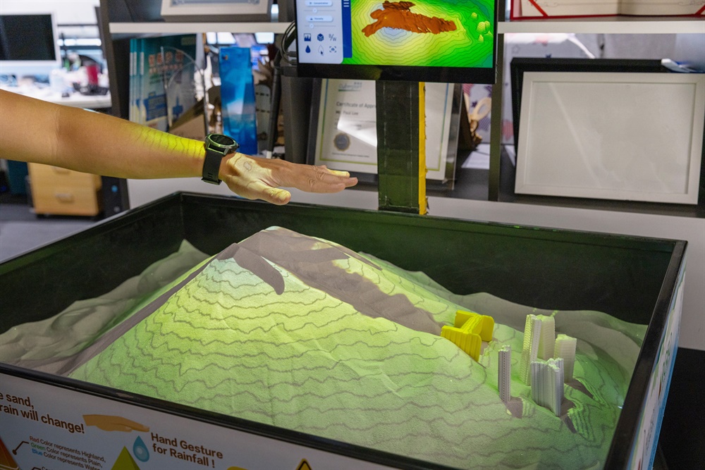 Photo 6 - STEM Corner - Intercepting Landslide with a Rigid Barrier: Participants can experience how the landslide from natural hillside is intercepted by a rigid barrier through Smart Sandbox